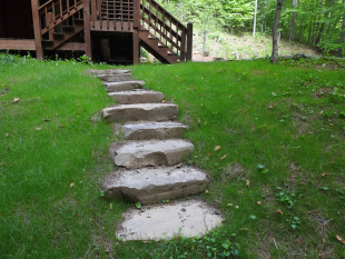 Stone steps down to the fire pit area by Gonzalez Landscaping and Home Improvement