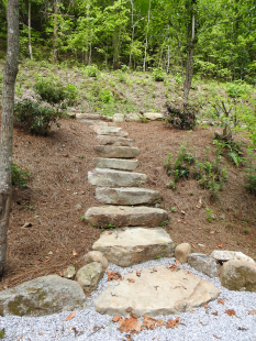 Close up of stone steps through landscaped hillside by Gonzalez Landscaping and Home Improvement